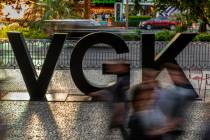 Fans stream by a VGK logo on Las Vegas Blvd. before the start of Game 4 of an NHL Western Confe ...