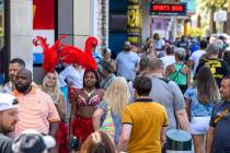 People walk along the Strip near The Venetian, most not wearing masks anymore on Friday, July 1 ...