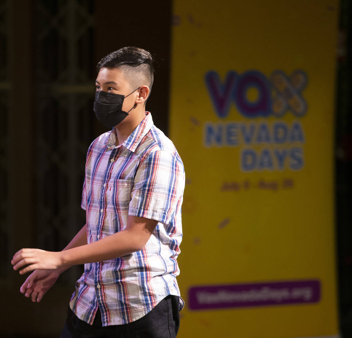 Brandan B. walks up to receive a check for a $50,000 college savings plan from Gov. Steve Sisol ...