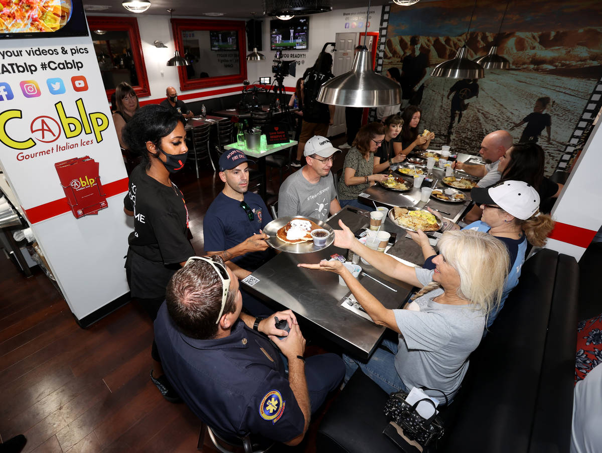 Daijah Miranda serves, from left, Moapa Valley Fire Chief Stephen Neel, firefighter Greg Johnso ...