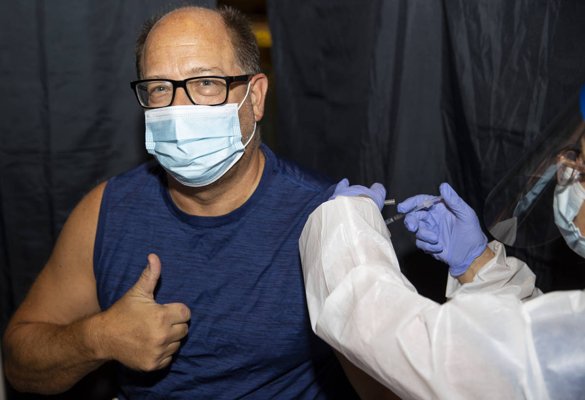 Robert Opalewski of Henderson is vaccinated during the #VivaVaxVegas vaccination clinic at Jimm ...