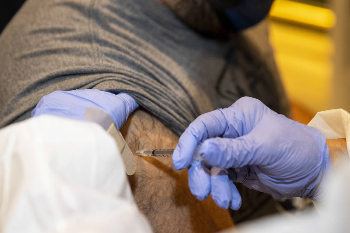 Bruno Calderone of Las Vegas is vaccinated by registered nurse Janice Williams during the #Viva ...