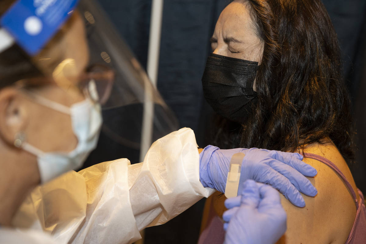 Jenny Richter of Las Vegas is vaccinated by registered nurse Janice Williams during the #VivaVa ...