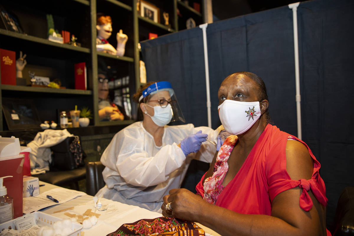 Toni Morrison of Las Vegas is vaccinated by registered nurse Janice Williams during the #VivaVa ...