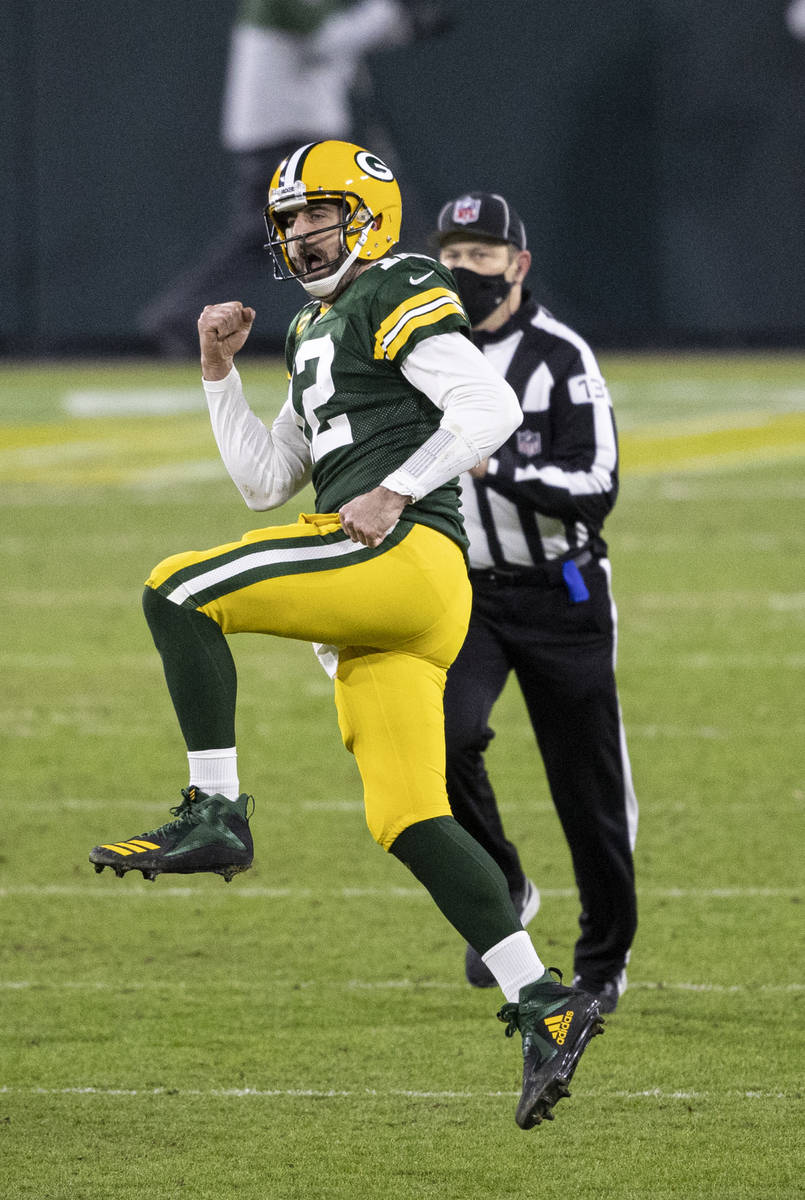 Green Bay Packers' Aaron Rodgers celebrates a touchdown pass during an NFL divisional playoff f ...