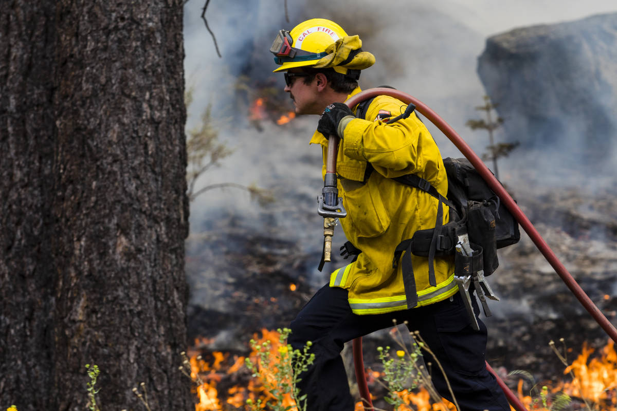 A So-Cal fireman battles the Tamarack Fire astir   California State Route 88 adjacent   Alpine Village ...
