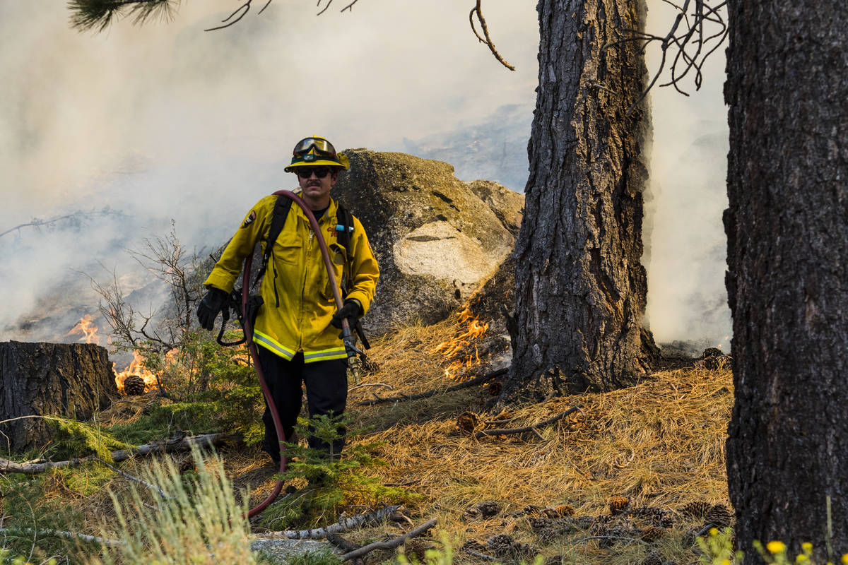 A So-Cal fireman battles the Tamarack Fire astir   California State Route 88 adjacent   Alpine Village ...