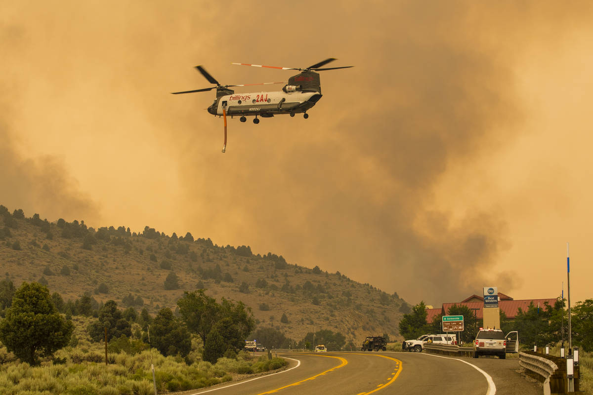 A firefighting chopper  flies arsenic  the Tamarack Fire burns astir   Topaz Lake, Nev., Friday, Jul ...