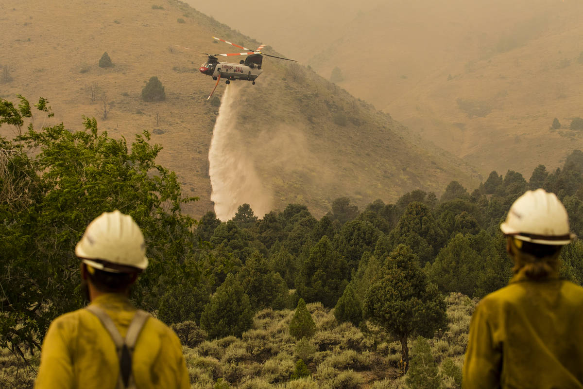 A firefighting chopper  drops h2o  arsenic  the Tamarack Fire burns astir   Topaz Lake, Nev., Frida ...