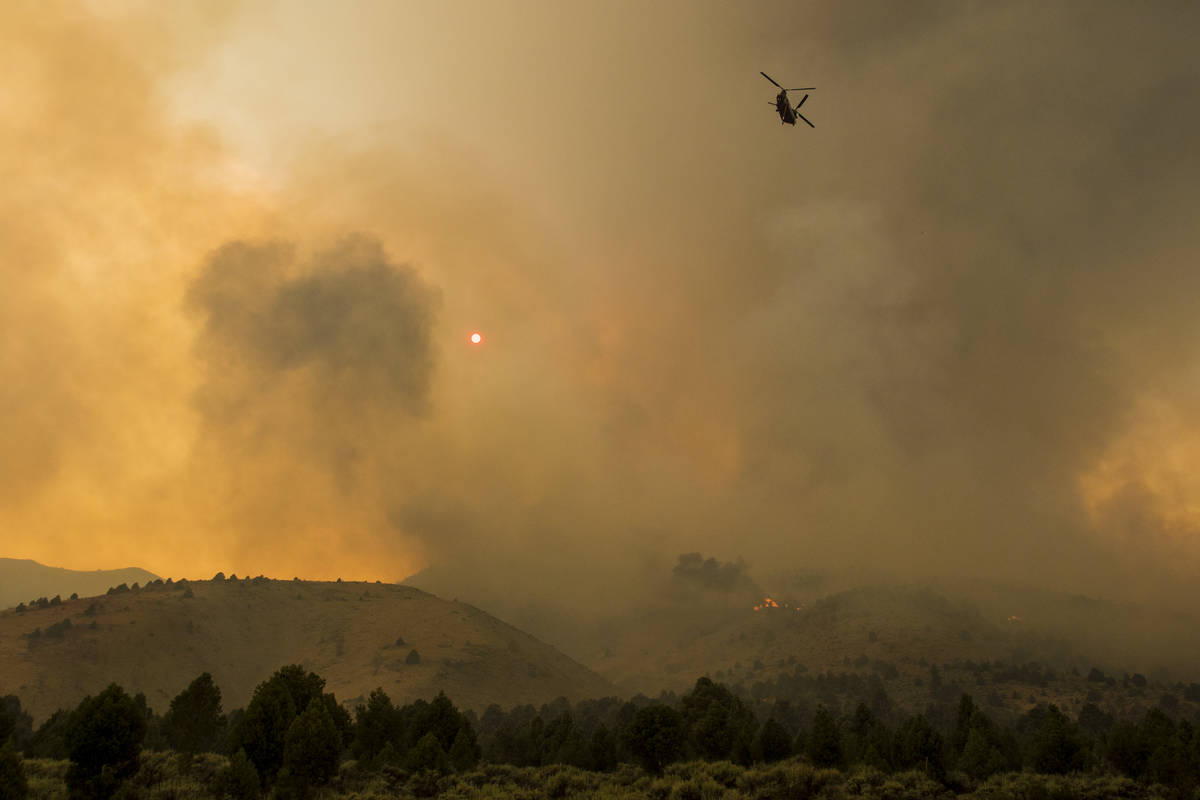 A firefighting chopper  flies arsenic  the Tamarack Fire burns astir   Topaz Lake, Nev., Friday, Jul ...