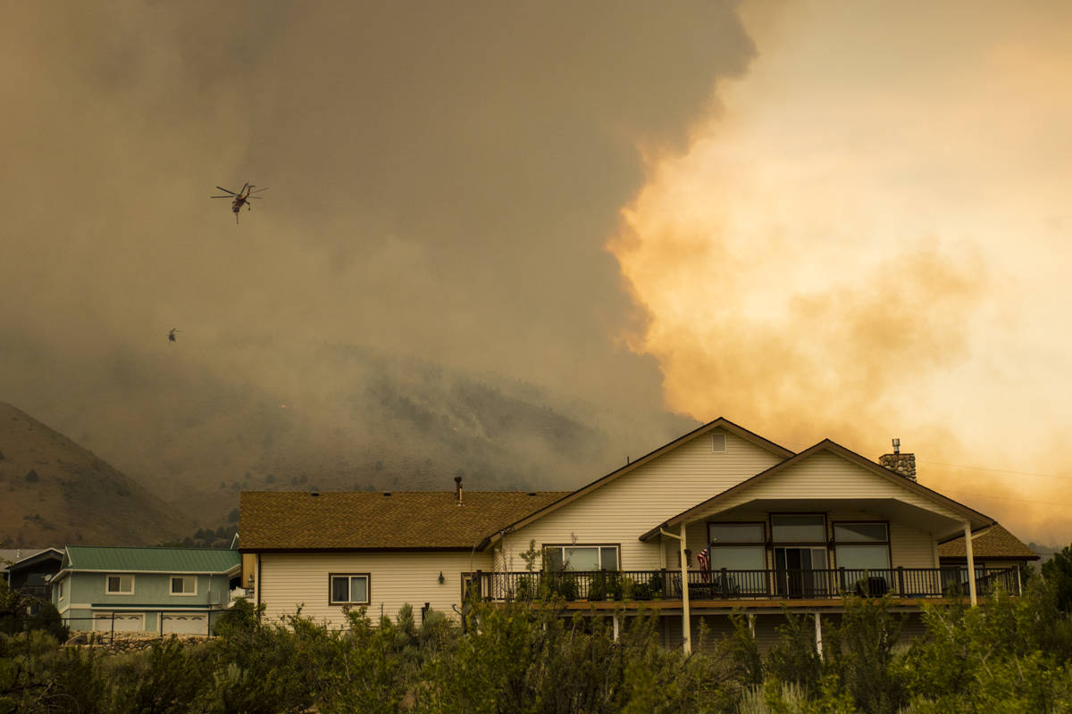 A firefighting chopper  flies arsenic  the Tamarack Fire burns astir   Topaz Lake, Nev., Friday, Jul ...