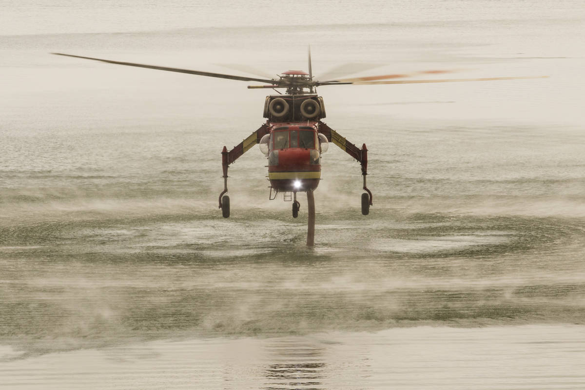 A firefighting chopper  is seen astatine  Topaz Lake, successful  Nevada, Friday, July 23, 2021, portion    the T ...