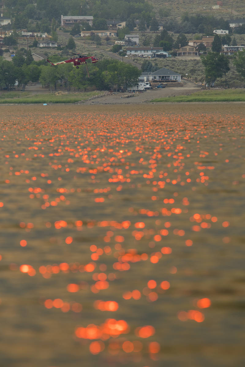 A firefighting chopper  flies arsenic  the Tamarack Fire burns astir   Topaz Lake, Nev., Friday, Jul ...