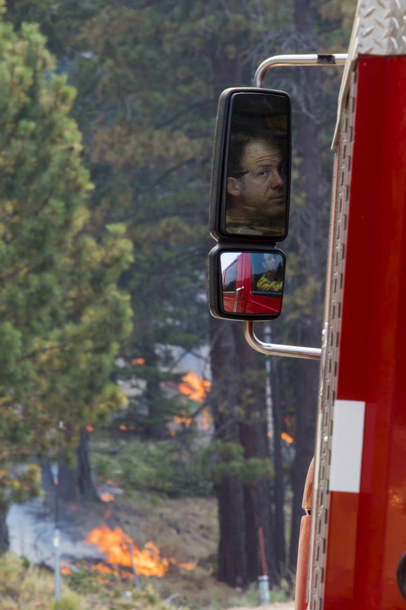 A So-Cal fireman is reflected successful  a broadside  reflector  astir   California State Route 88 adjacent   Alpine Vil ...