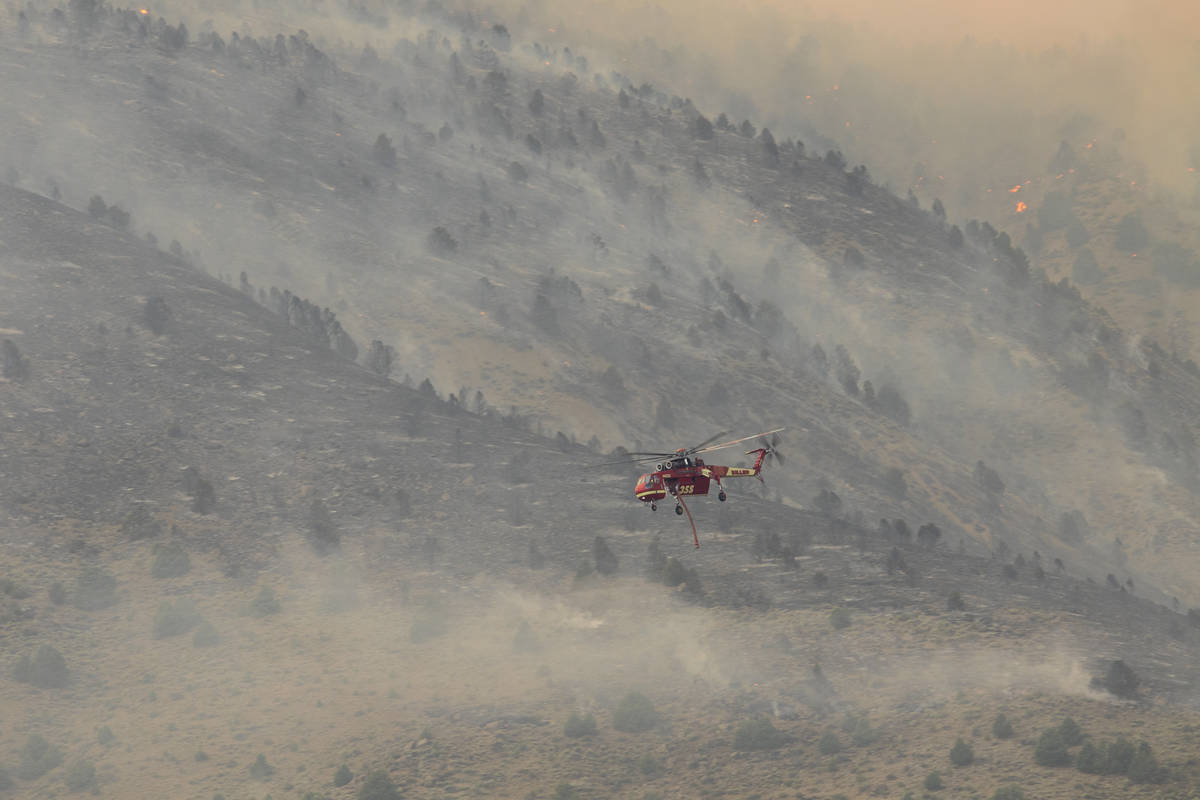 A firefighting chopper  flies arsenic  the Tamarack Fire burns astir   Topaz Lake, Nev., Friday, Jul ...