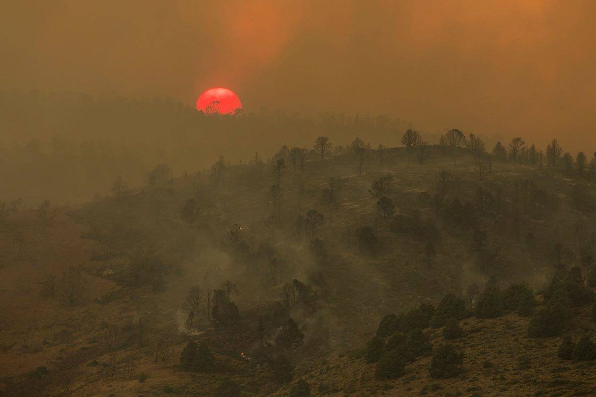 Sunset is seen as the Tamarack Fire burns around Topaz Lake, Nev., Friday, July 23, 2021. Nevad ...