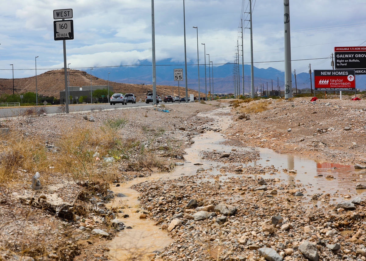Water flows in a ditch adjacent to Blue Diamond Road in Las Vegas, Monday, July 26, 2021. (Rach ...