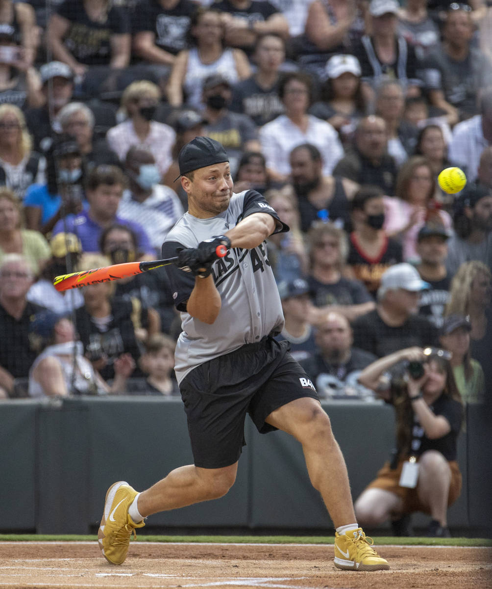 Las Vegas Raiders Alec Ingold (45) eyes a pitch while hitting during a charity softball game ve ...