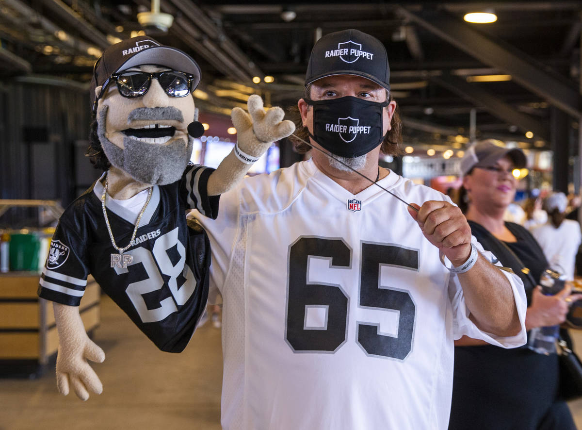 The Raider Puppet makes an appearance during a charity softball game involving teammates from t ...