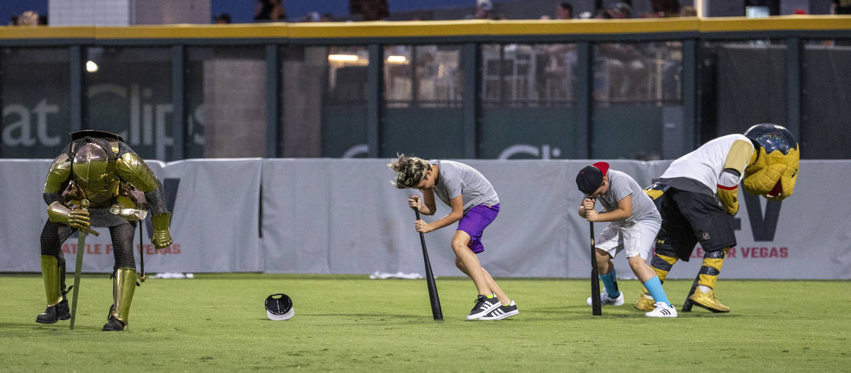 The Golden Knight and Chance the Gila Monster join in the ÒDizzy Bat RaceÓ during a c ...