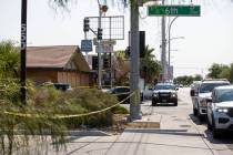 Las Vegas police, with the assistance of animal control, investigate the scene where a dog was ...
