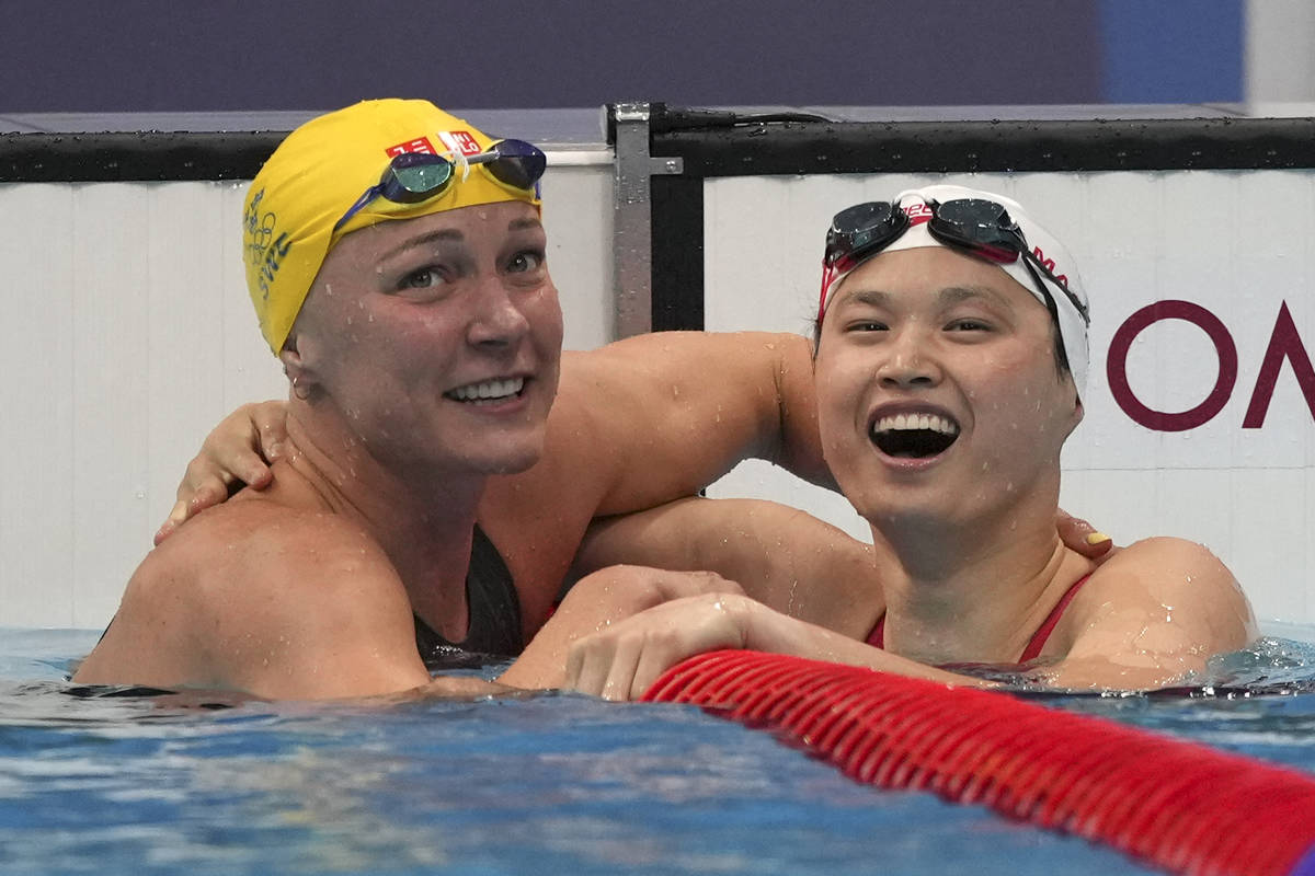 Margaret MacNeil, right, of Canada, is congratulated by Sarah Sjoestroem of Sweden103 aft  triumph   ...