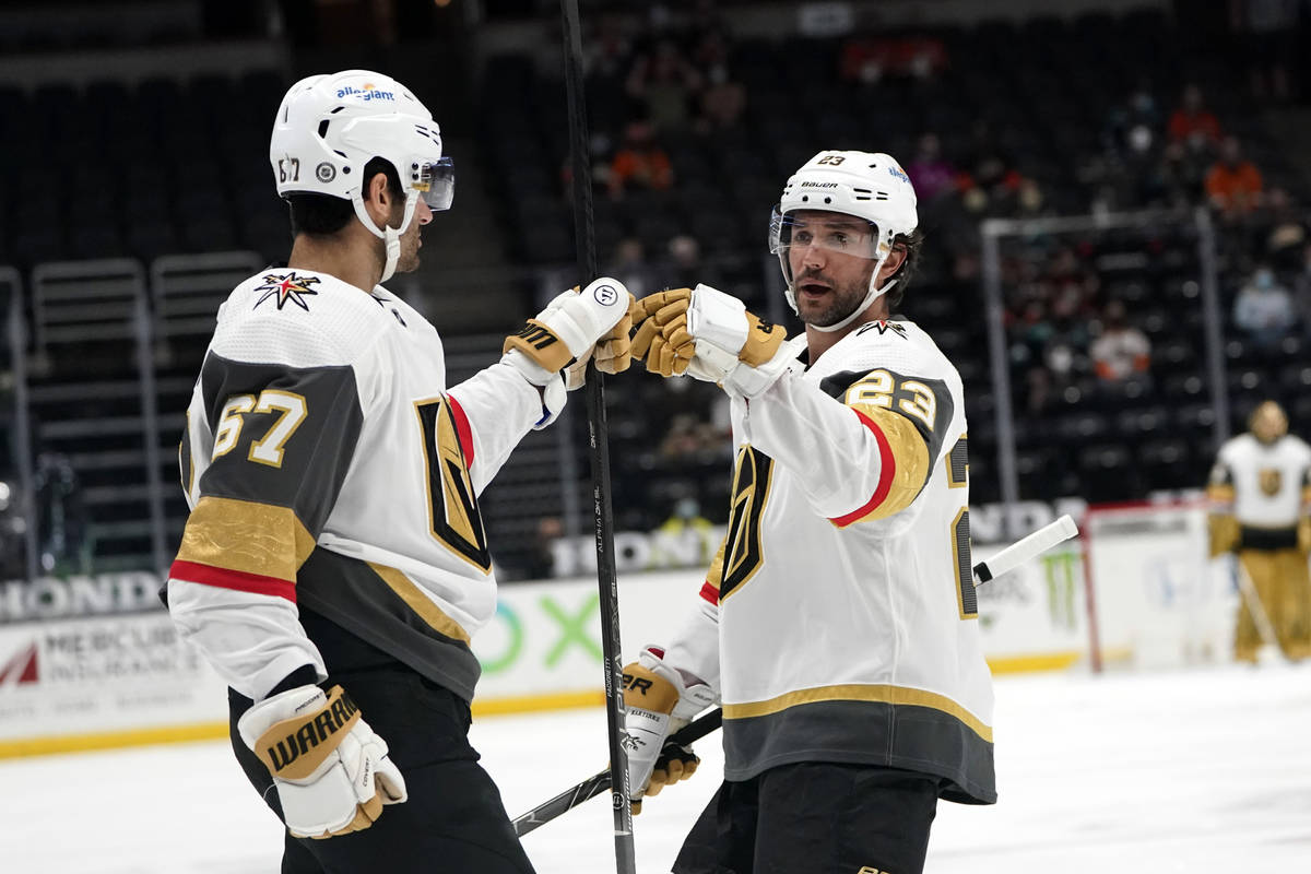 Vegas Golden Knights left wing Max Pacioretty (67) celebrates his goal with Alec Martinez (23) ...