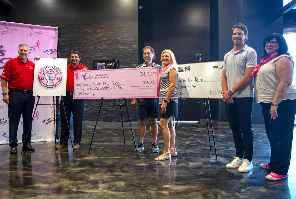 Vegas Golden Knights defenseman Shea Theodore, second from right, poses with, from left, Compre ...