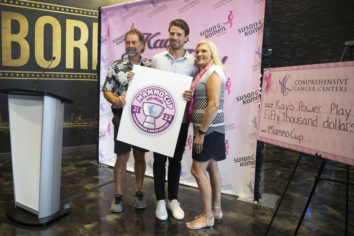 Vegas Golden Knights defenseman Shea Theodore, center, poses with his parents, Cam Theodore, le ...