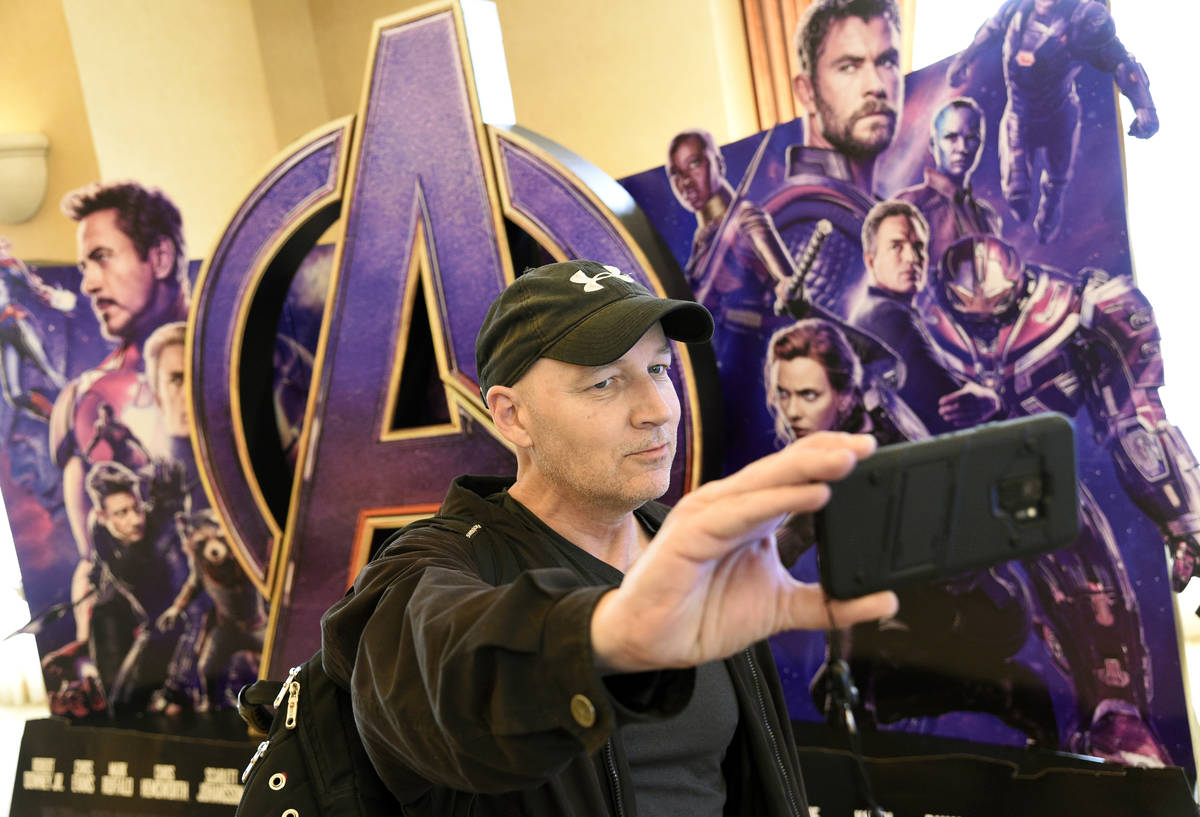CinemaCon attendee Luis Saint Amant, of Argentina, takes a selfie in front of an advertisement ...