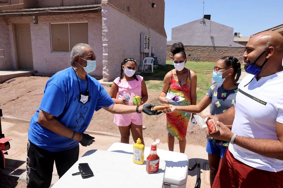 Willie Cherry with Willie R. Cherry Ministries offers free hot dogs, drinks and chips to Alex N ...