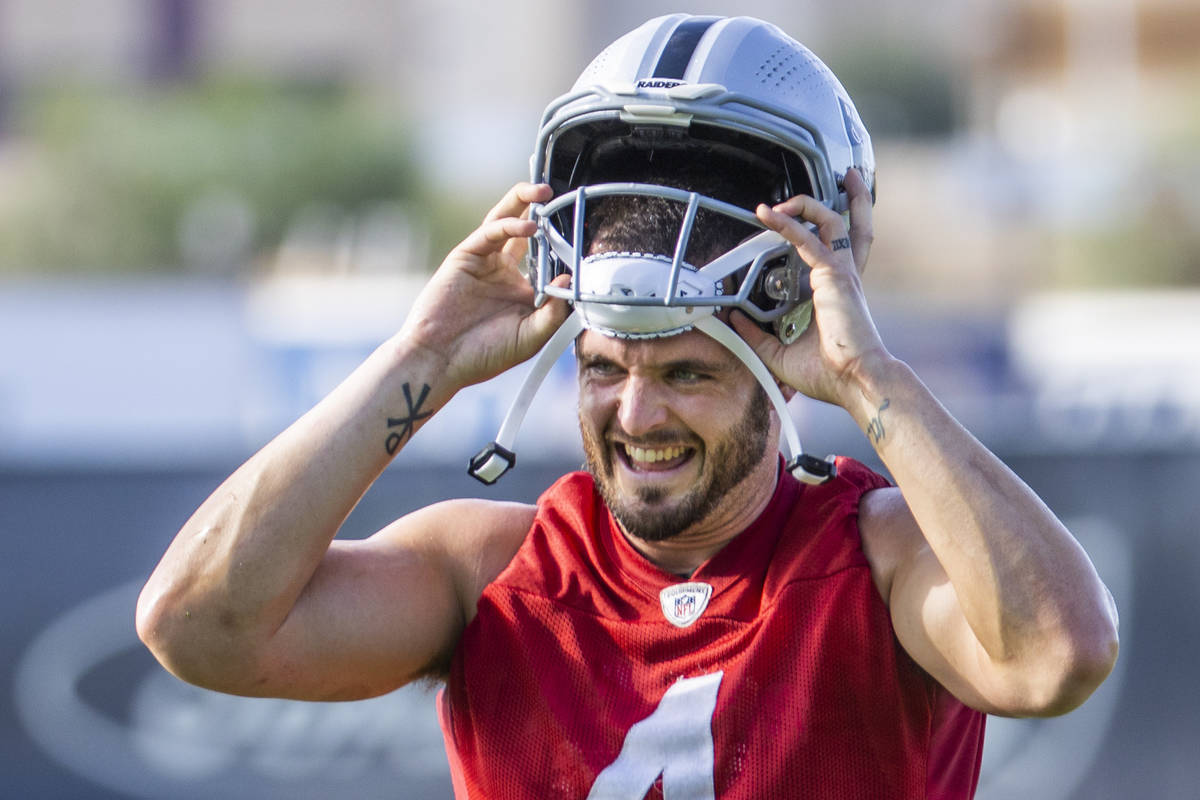 Raiders quarterback Derek Carr (4) looks to teammates during the Raiders training camp at the I ...