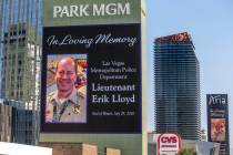 The marquee at Park MGM honors Las Vegas police Lt. Erik Lloyd as his funeral procession moves ...
