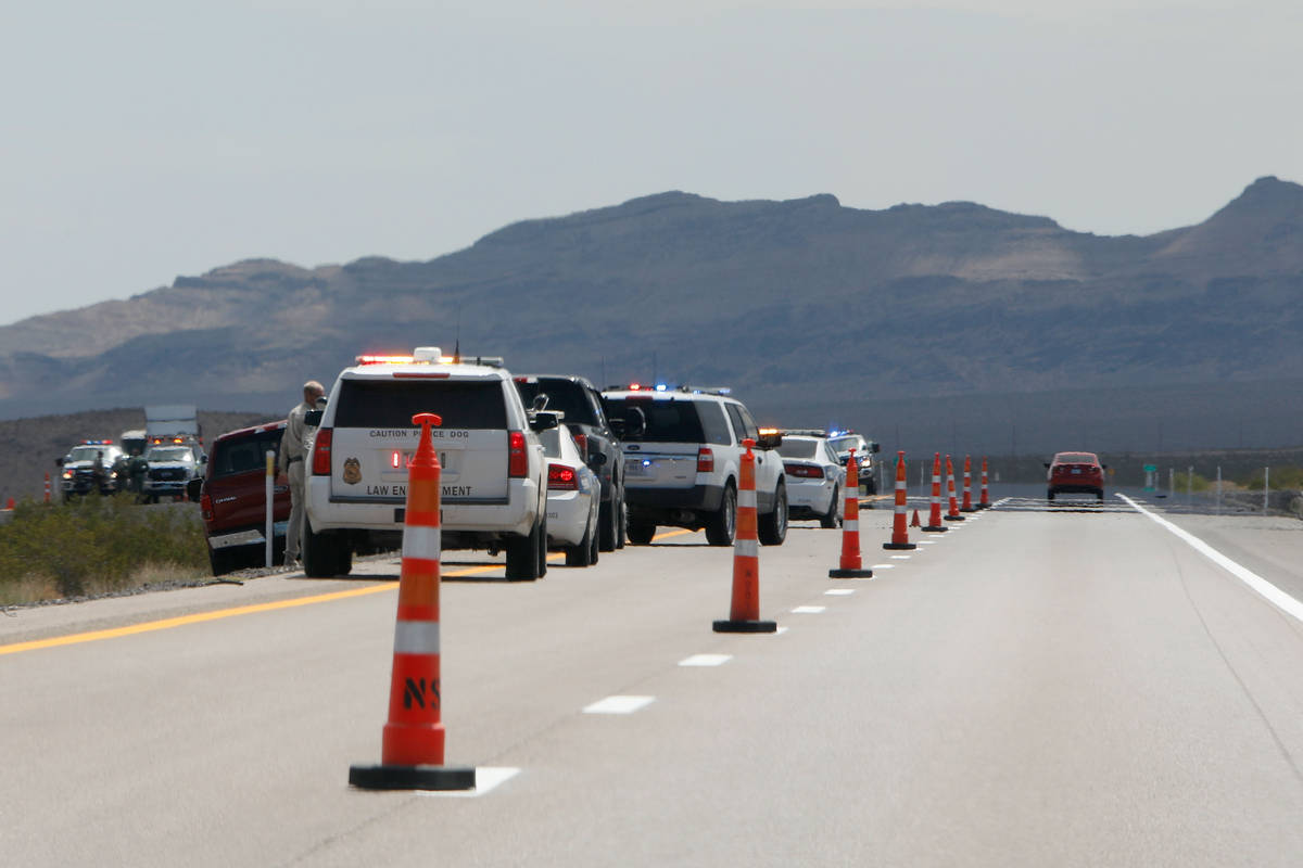 Law enforcement officers investigate a plane crash on U.S. Highway 95, around Nye County border ...