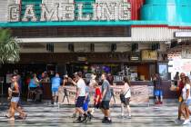 Visitors walk under the Fremont Street Experience in Downtown Las Vegas Wednesday, July 28, 202 ...