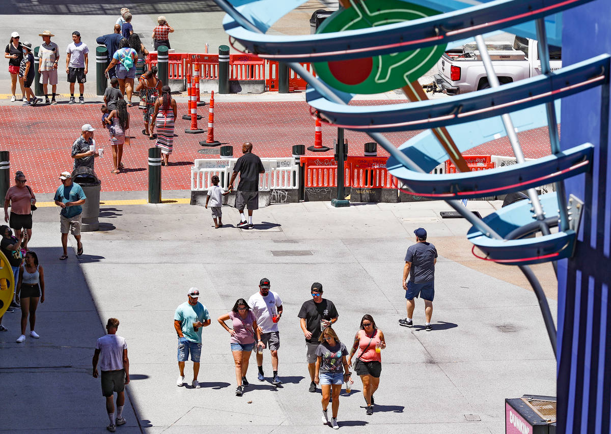 Visitors walk on the Fremont Street Experience in Downtown Las Vegas Wednesday, July 28, 2021. ...