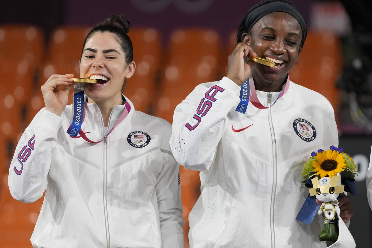 Members of team United States Kelsey Plum, left, and Jacquelyn Young pose with their gold medal ...