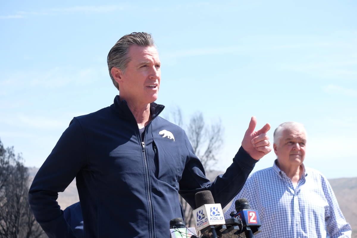Calif Gov. Gavin Newsom, joined by Nev. Gov. Steve Sisolak, speaks to reporters Wednesday in Ga ...