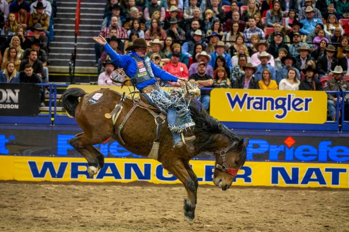 Spencer Wright of Milford, Utah, kicks back for the crowd in Saddle Bronc Riding at the tenth g ...