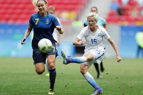 In this Friday, Aug. 12, 2016, file photo, United States' Megan Rapinoe, right, kicks the ball ...