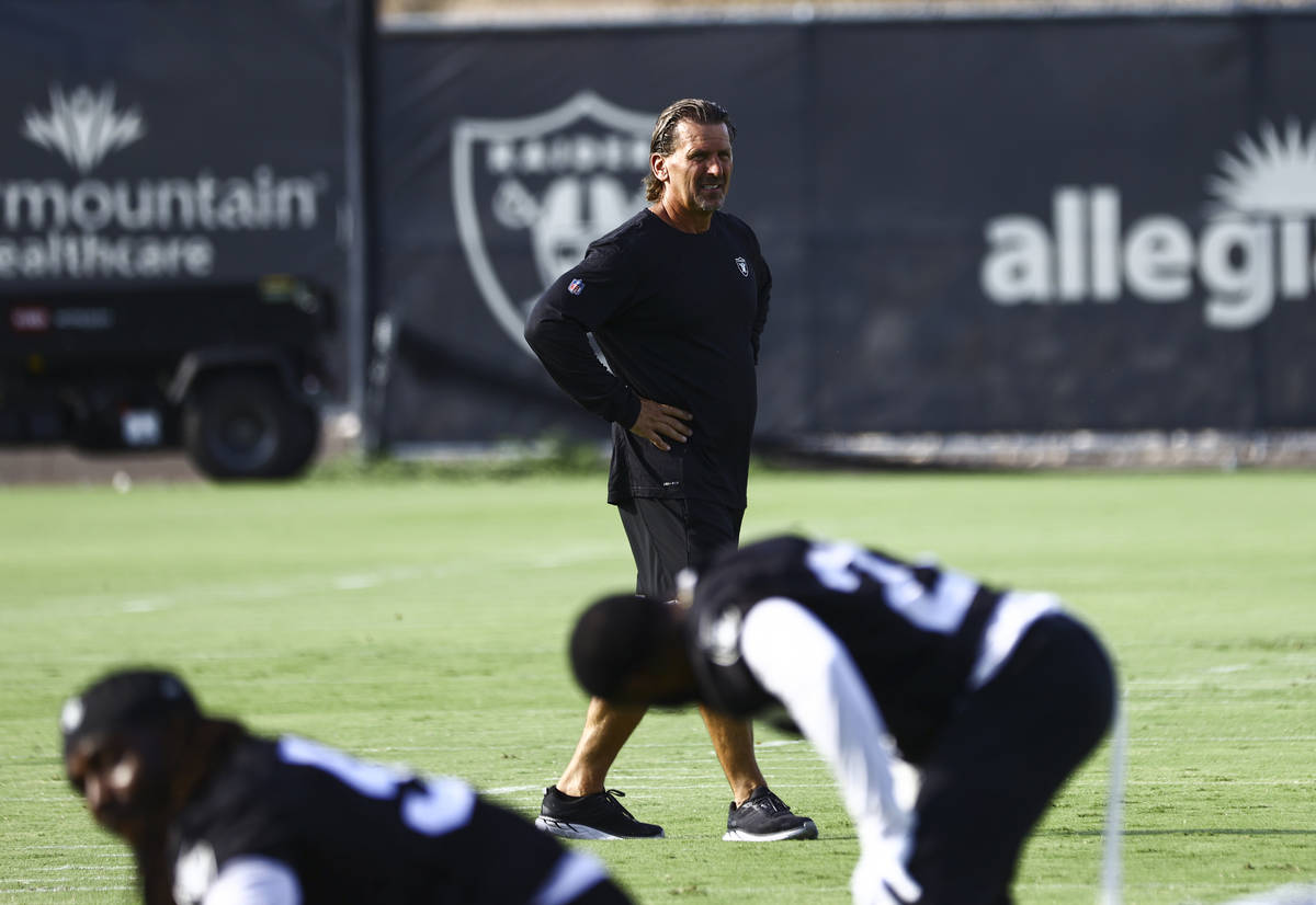 Raiders offensive coordinator Greg Olson walks the field during training camp at Raiders Headqu ...