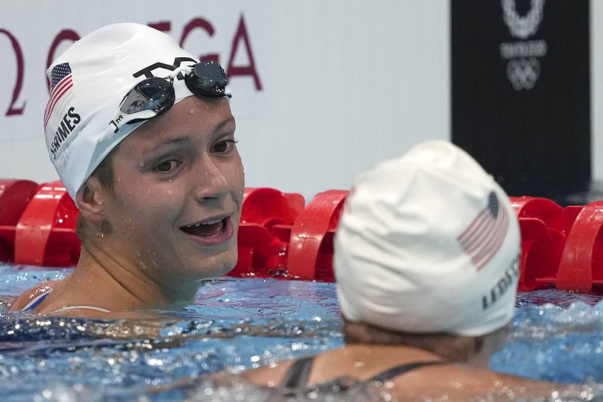 Katie Grimes, left, of the United States, talks with teammate Katie Ledecky, following their he ...