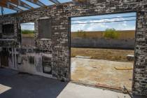 An exposed interior brick wall a burned-out house that is currently listed for sale along the 3 ...