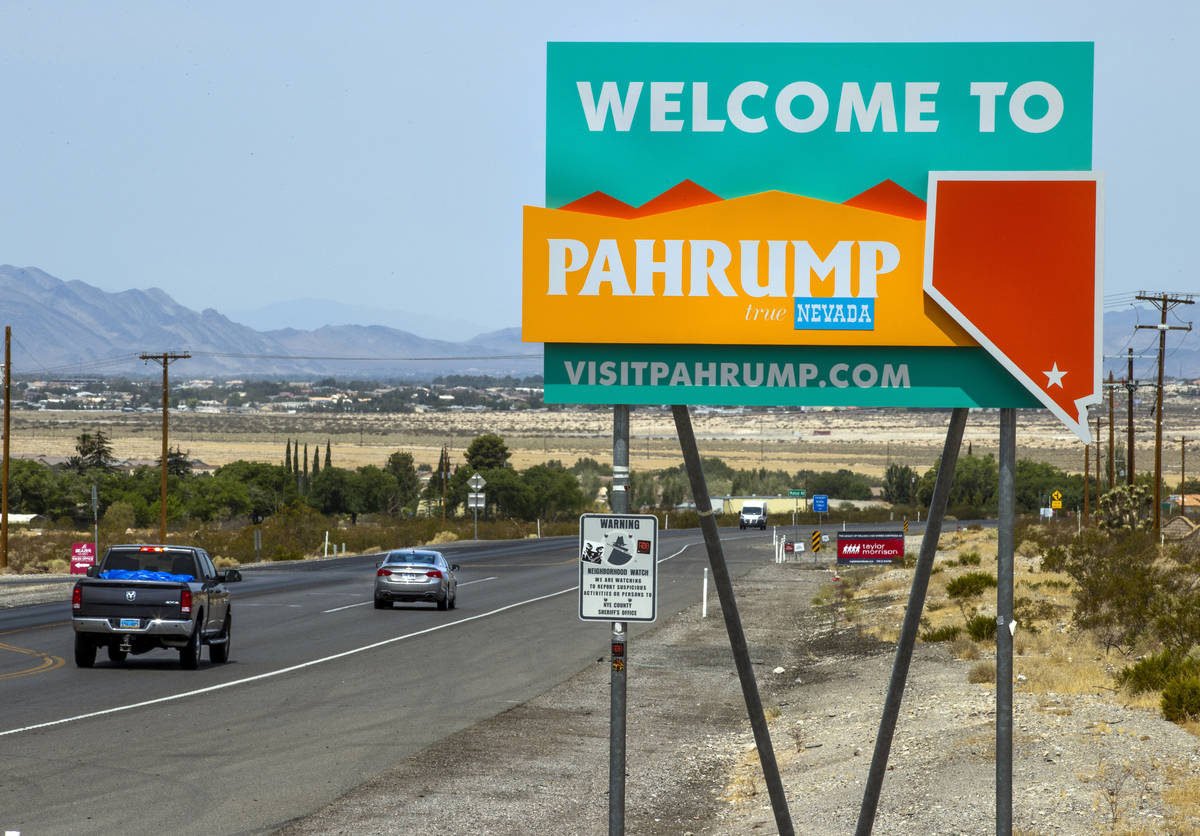 Traffic moves along at the city line for Pahrump, television station KPVM there is the setting ...