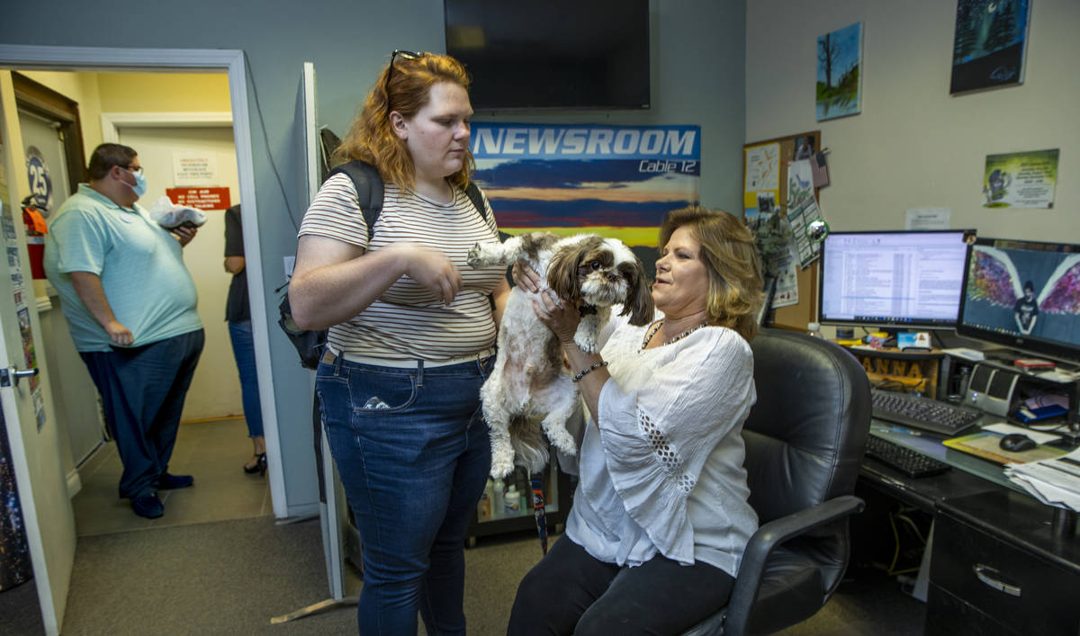 KPVM 25 News Director/Anchor Deanna O'Donnell, right, passes her dog Tommy off to daughter Darb ...