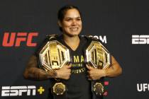 UFC women's bantamweight and featherweight champion Amanda Nunes poses with her belts during a ...