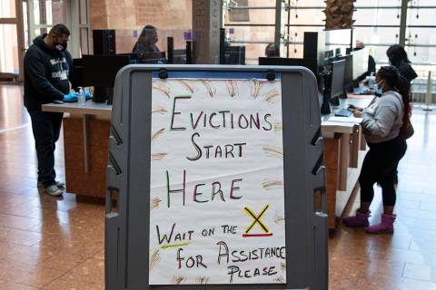 Tenants, who received an eviction notice from their landlord, fill out forms at the Civil Law S ...