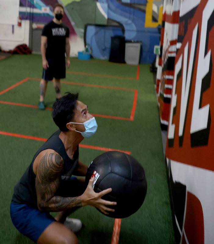 Bong Hidalgo works out with lead coach Michael Hayden at Real Results Fitness gym in downtown L ...