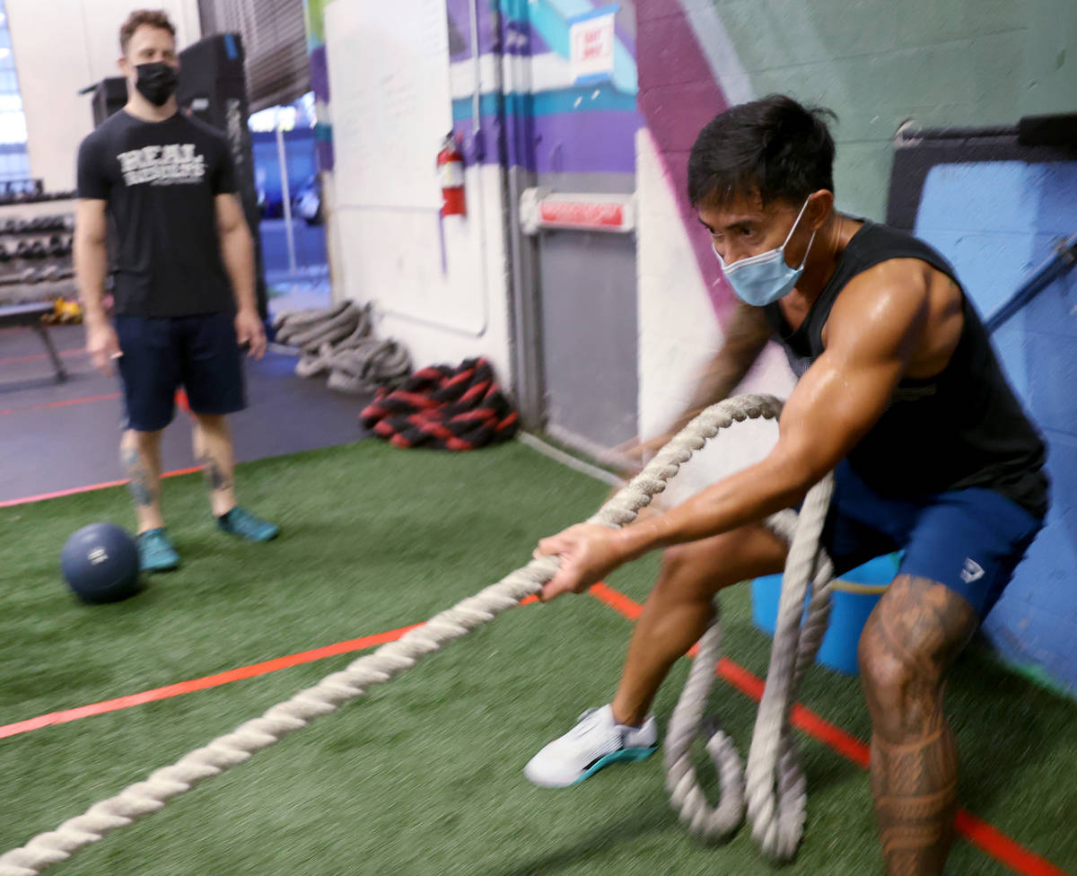 Bong Hidalgo works out with lead coach Michael Hayden at Real Results Fitness gym in downtown L ...