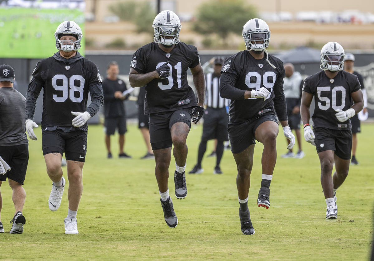 (From left) Raiders defensive end Maxx Crosby (98), defensive end Yannick Ngakoue (91), defensi ...